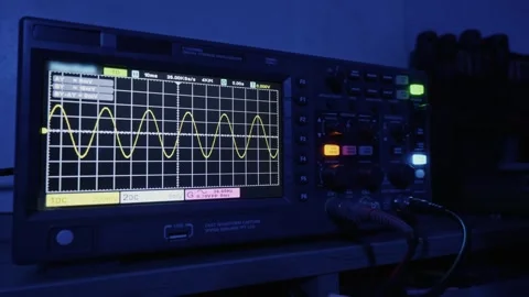 Electronic Oscilloscope Screen Showing A Yellow Sine Wave Analysis Signal Stock Footage 327854378