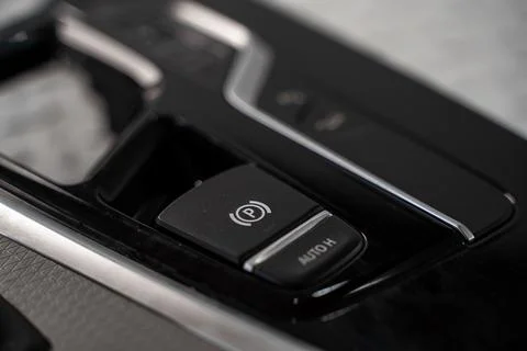 Electronic parking brake switch in a car center console Stock-Fotos