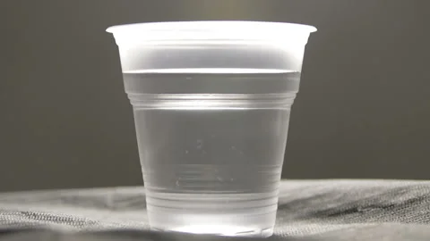 Electronic pen tattoo machine inject paint in the cup of clean water Stock Footage 102814701