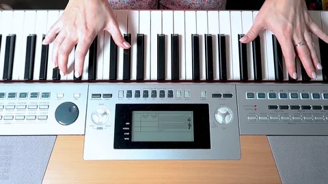 Electronic piano. Human hands playing the piano, top view 動画素材 128440476