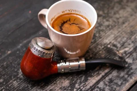 Electronic pipe and cup of coffee Stock Photos