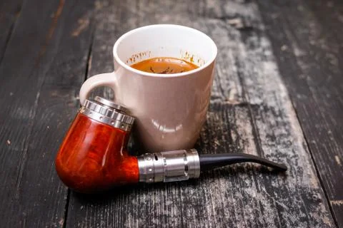 Electronic pipe and cup of coffee Stock Photos
