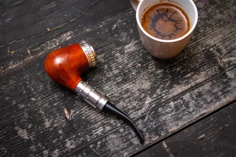 Electronic pipe and cup of coffee Stock Photos