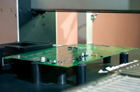 Electronic printed circuit Board on the table of the robot manipulator Stock Photos