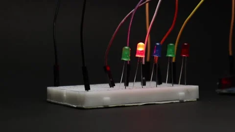 Electronic prototyping projects on a breadboard with multiple colored LED Stock Footage 334123112