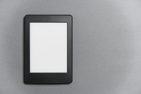 Electronic reader with blank screen on gray background. Concept of technology Stock Photos