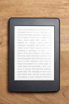 Electronic reader on a wooden surface. Concepts of technology and reading Stock Photos