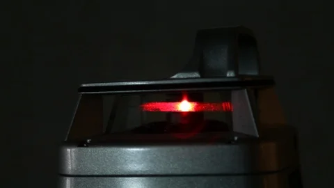 Electronic red light level projector in a garage under construction Stock Footage 95757432