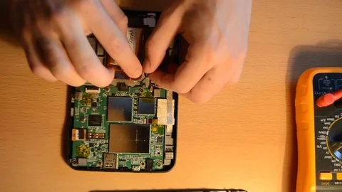 Electronic repairing process using solder and multimeter. V10 Stock Footage 92072013