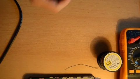 Electronic repairing process using solder and multimeter. V11 Stock Footage 92072023