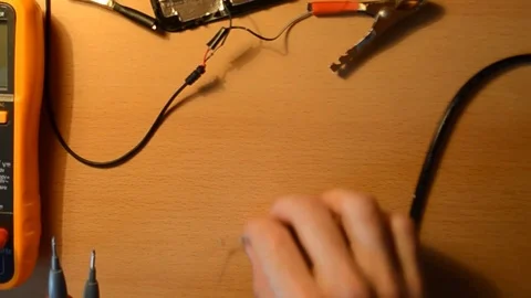 Electronic repairing process using solder and multimeter. V13 Stock Footage 92072054