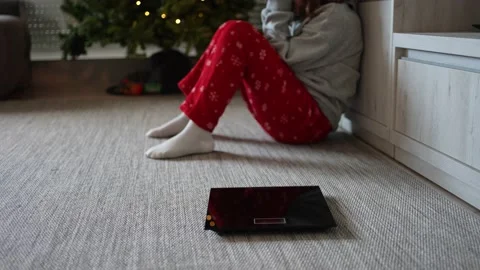 Electronic scale and in the background a young woman sitting on the floor Stock Footage 168184623