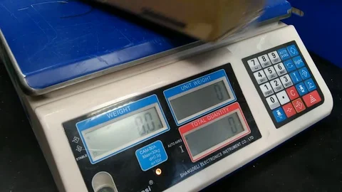 Electronic scales. Determining the weight of the mail package. Stock Footage 71409190