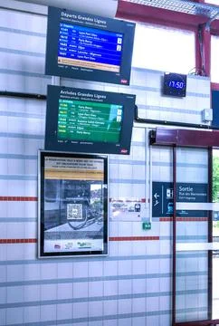 Electronic schedule monitors showing train arrival and departure times at s.. Stock Photos