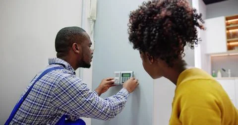 Electronic Security Alarm System Install. Professional Installer Stock Photos