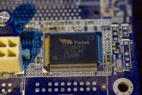 Electronic semiconductor chip mounted on a blue motherboard featuring various Foto stock