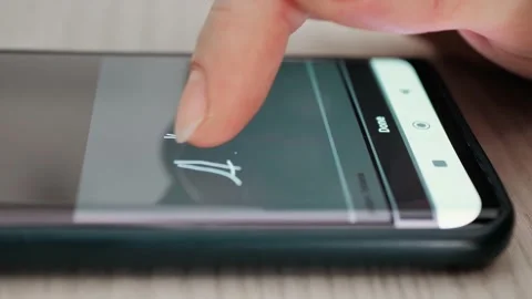 Electronic signature on tablet computer by hand. Sign Document of deal on Stock Footage 228229483