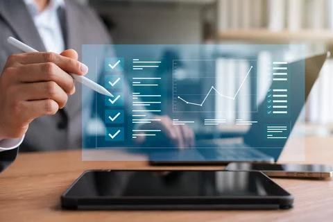 Electronic smart checklist, businessman using laptop and tablet checking bu.. Stock Photos