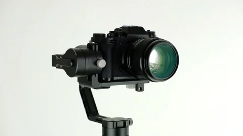 Electronic steadycam with digital camera rotates on white background. Stock Footage 109430794