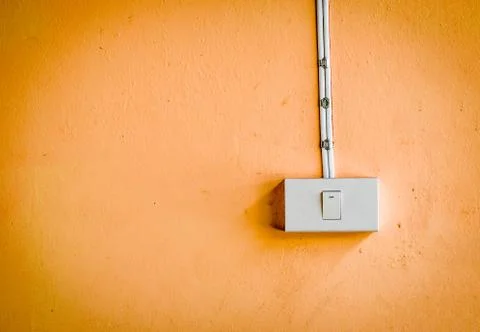 Electronic switch on orange color wall Stock Photos