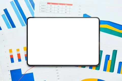 Electronic tablet to copy space on sheets with graphs and reports Stock Photos
