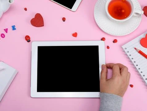 Electronic tablet with an empty white screen in female hands Stock Photos