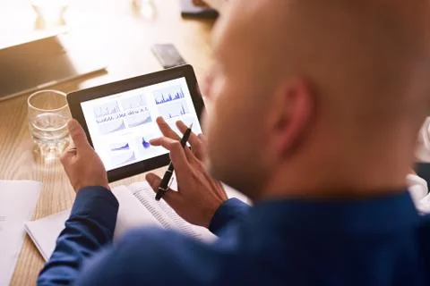 Electronic tablet with graphs on being used by business professional Stock Photos