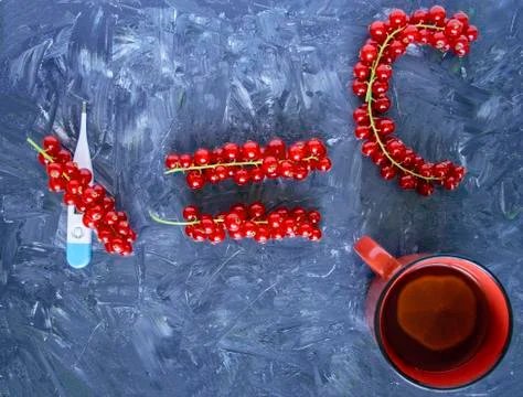Electronic thermometer, cold protection, equal sign made of berries, C character Stock Photos