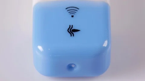 Electronic thermometer lies on a white table. Moving camera on the slider. Macro Stock Footage 73828454