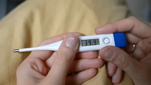 Electronic thermometer shows a temperature of 39.9 degrees Celsius Stock Footage 121321418