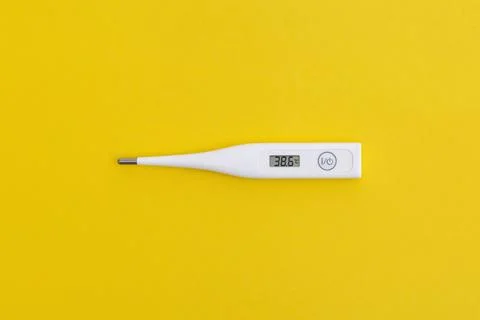 Electronic thermometer on yellow background Stock Photos