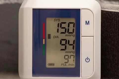 Electronic tonometer on the background of a cardiogram Stock Photos