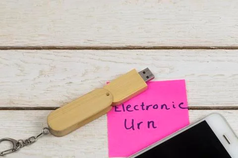 Electronic urn concept: flash drive and cell phone on white background Stock Photos