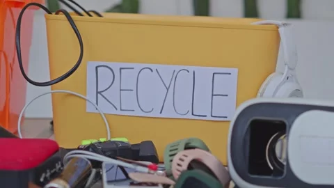 Electronic waste collection container with old technology gadgets for recycling Stock Footage 340578969