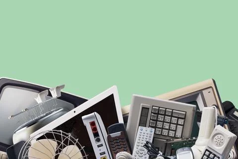 Electronic Waste Heap Concept with Discarded Tech Devices over Green Backgrou Stock Photos