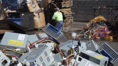 Electronic waste with man sweeping in background 4K 스톡 동영상 100839521