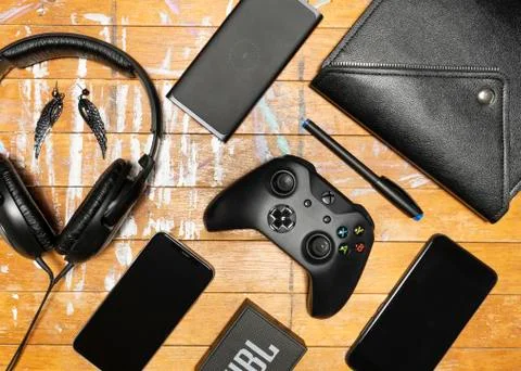 Electronics and other stuff on brown wooden table Stock Photos