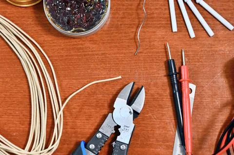 Electronics and soldering tool flat lay including multimeter, wire cutters, and Fotos de archivo