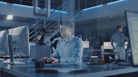 Electronics Development Engineer Sitting at His Desk Uses Personal Computer Stock Footage 104595878