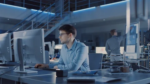 Electronics Development Engineer Sitting at His Desk Uses personal Computer Stock Footage