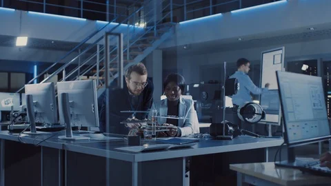 Electronics Development Engineer Talks with Project Manager, they Choose PCB Stock Footage 104587391