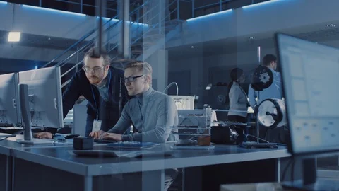 Electronics Development Engineer Uses Personal Computer Talks with Manager Stock Footage 104595636