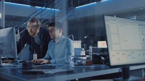 Electronics Development Engineer Uses Personal Computer Talks with Manager Stock Footage 104595774
