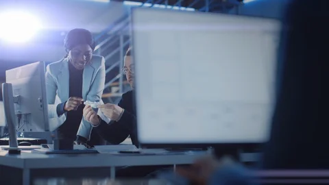 Electronics Development Engineer Working at His Desk, Talks with Project Manager Stock Footage 104554181
