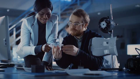 Electronics Development Engineer Working at His Desk, Talks with Project Manager Stock Footage 104554547