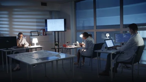 Electronics Development Engineers in white coats working on personal computers Stock Footage 112864947