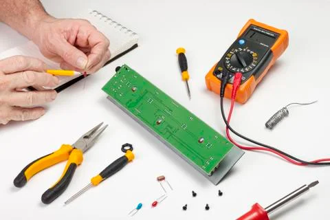 Electronics engineer checking the value of a resister component Stock Photos