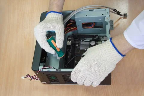 Electronics engineer create a modern personal computer. Hands of closeup. Stock Photos