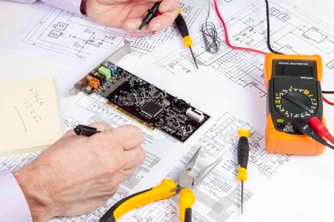 Electronics engineer making changes to a computer circuit diagram Foto stock