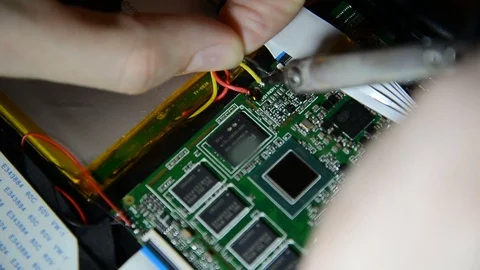 Electronics engineer is soldering an electric board with processors in a dark Stock Footage 73502976